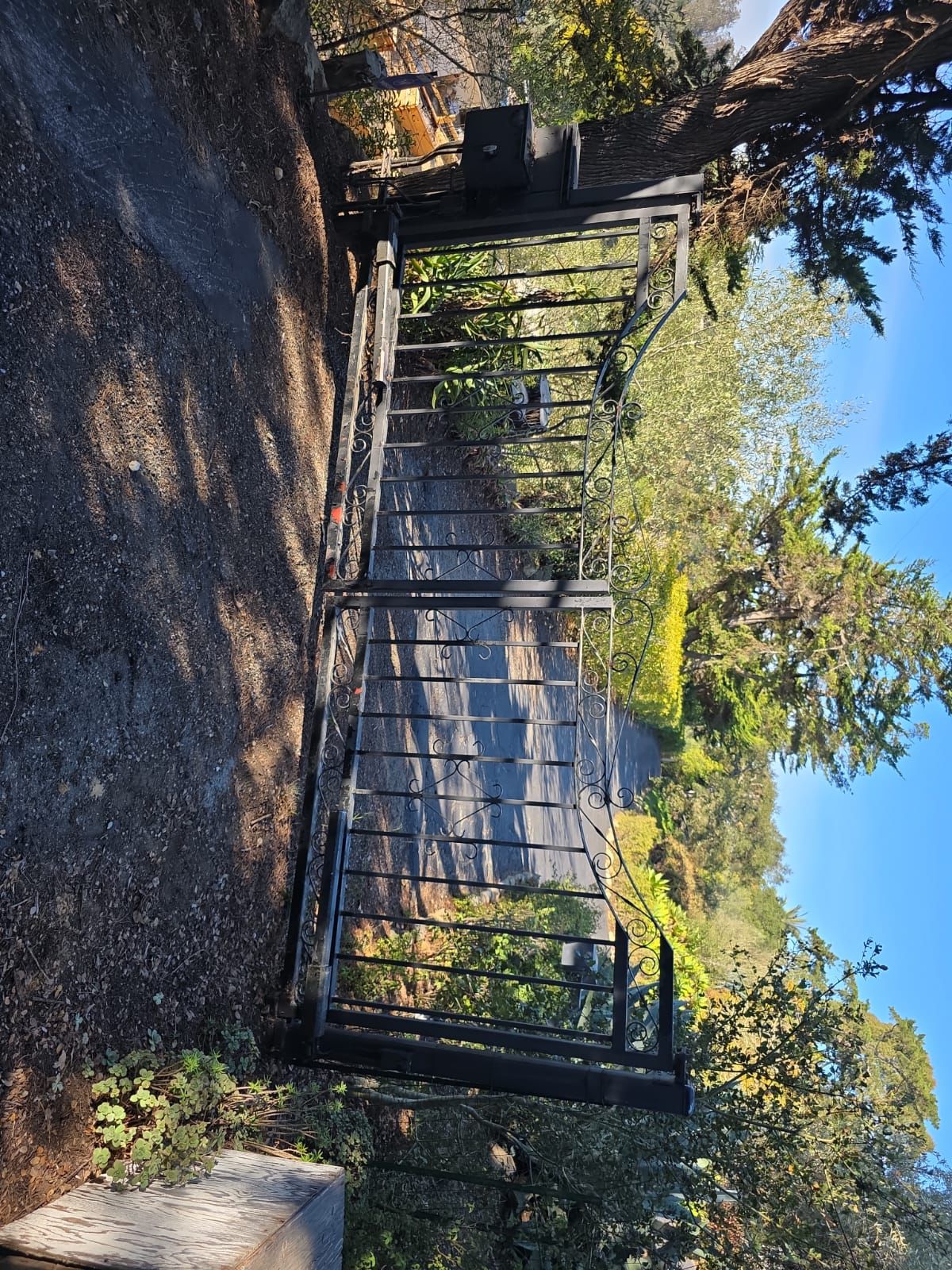 Ornamental iron swing gate repair Los Angeles hillside property